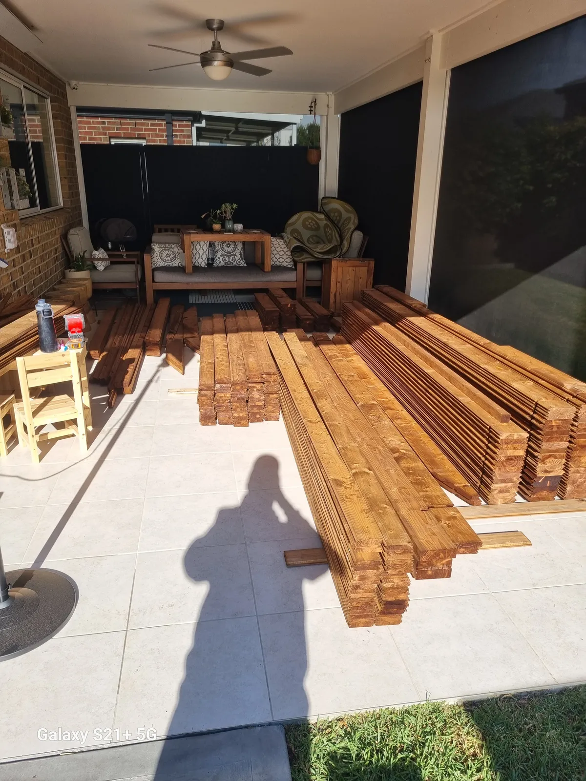 Pre-stained timber cladding stacked on the alfresco ready for the cabin build