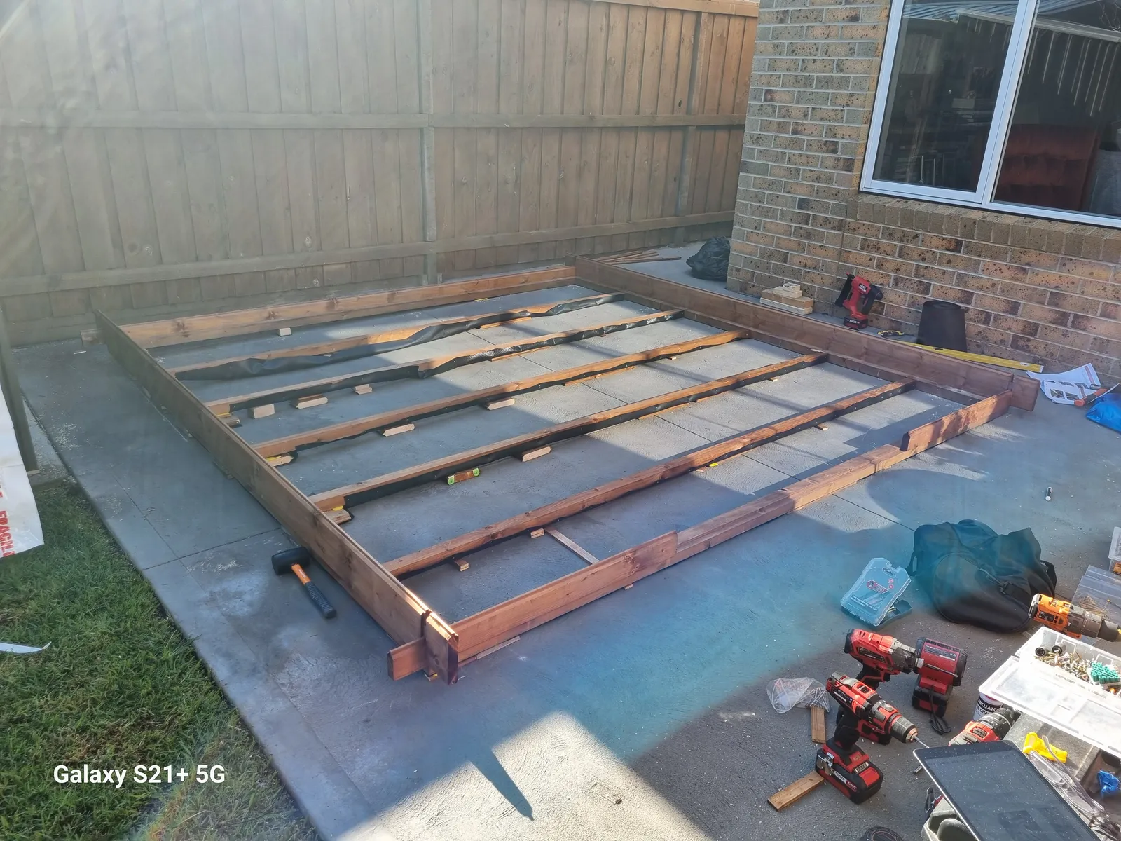 Cabin floor frame and bearers laid out on the existing concrete pad