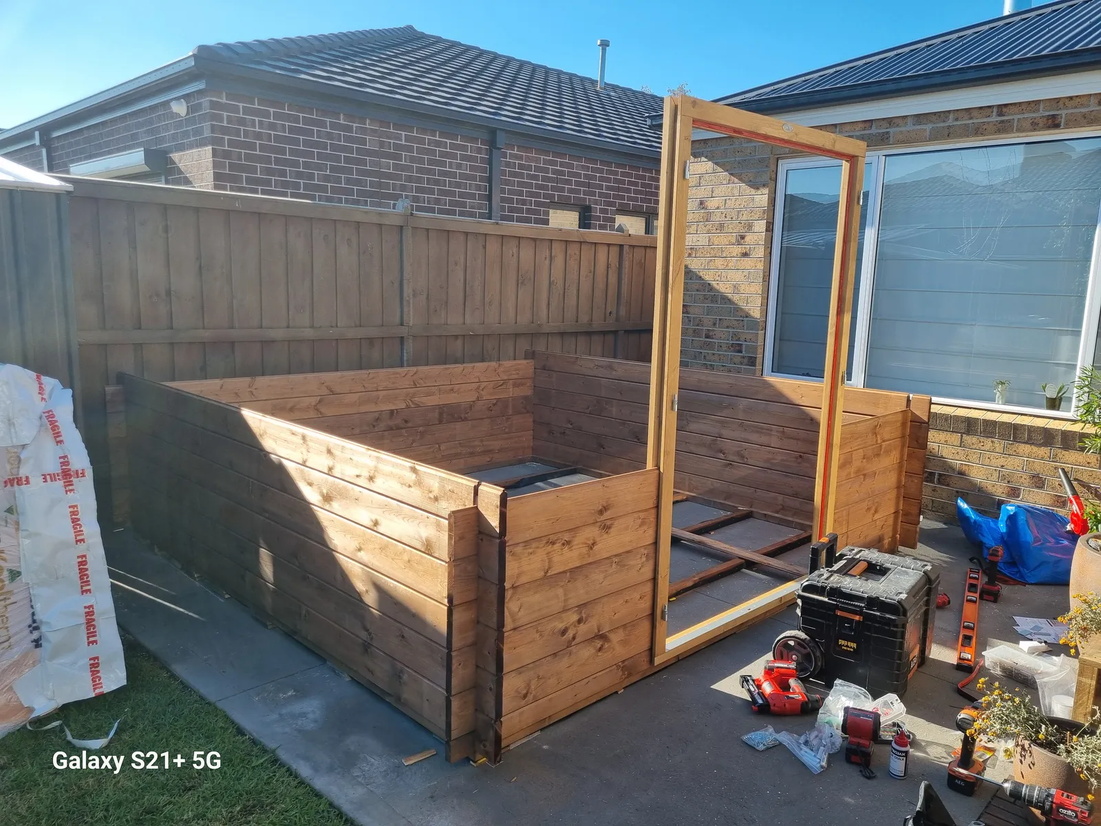 Cabin walls going up with door frame in place