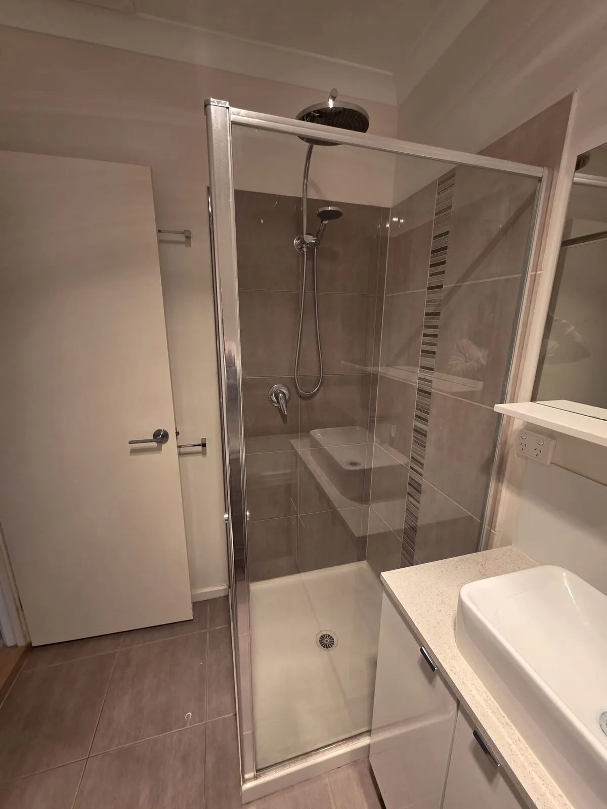 Original tired shower stall before the full bathroom renovation began